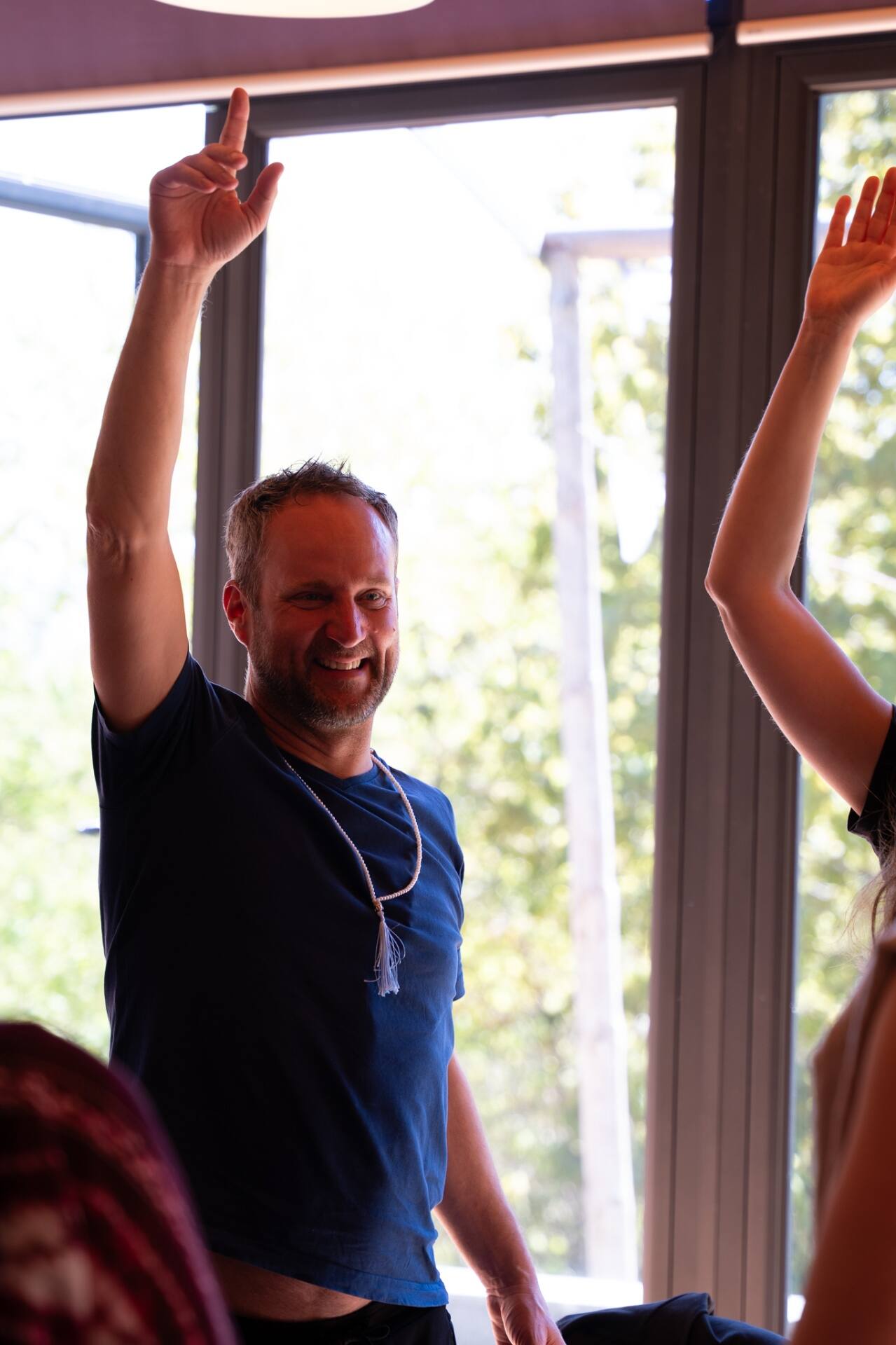 A participant smiling with arms raised in celebration