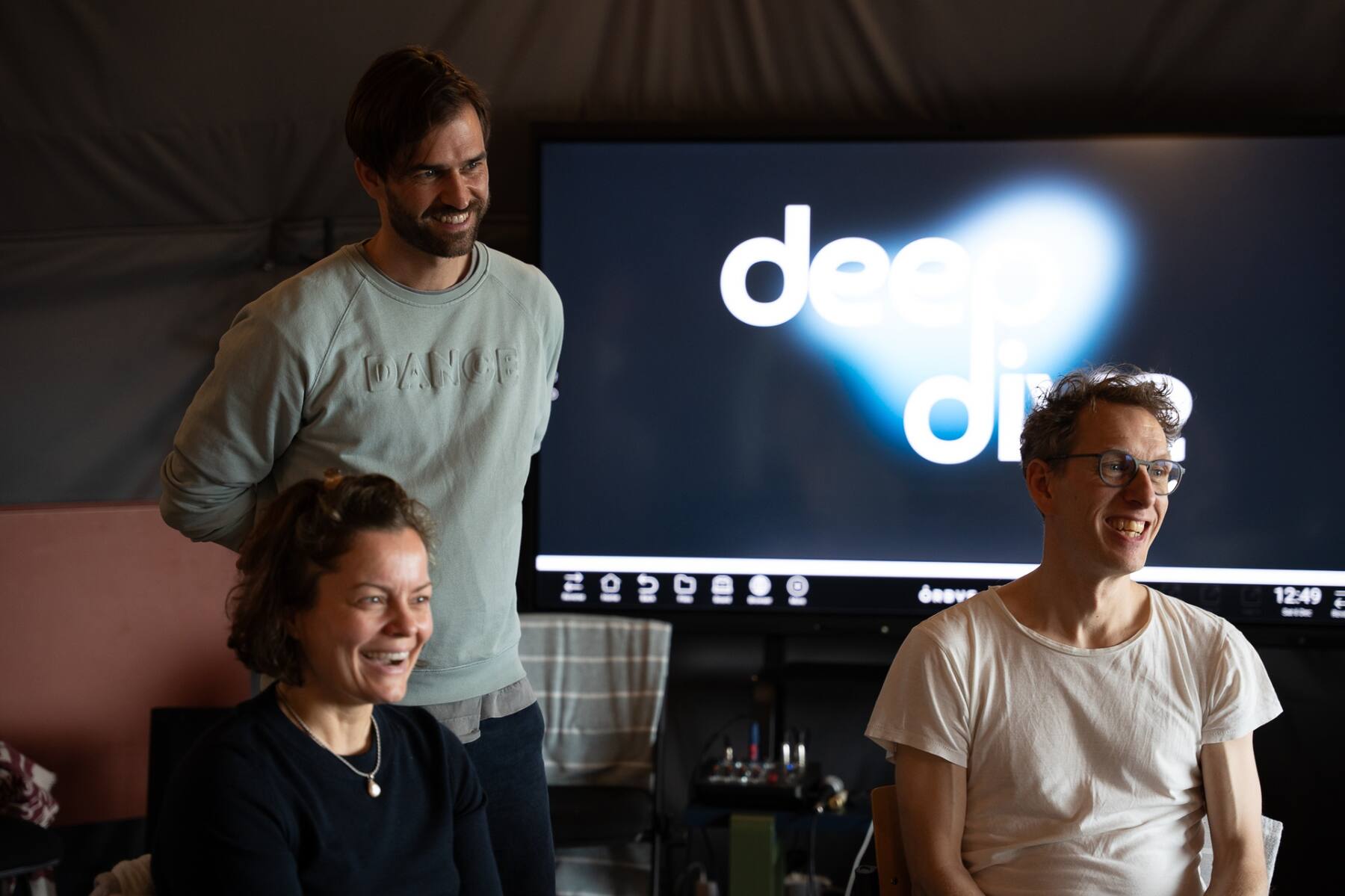 Participants laughing together during a Deepdive session