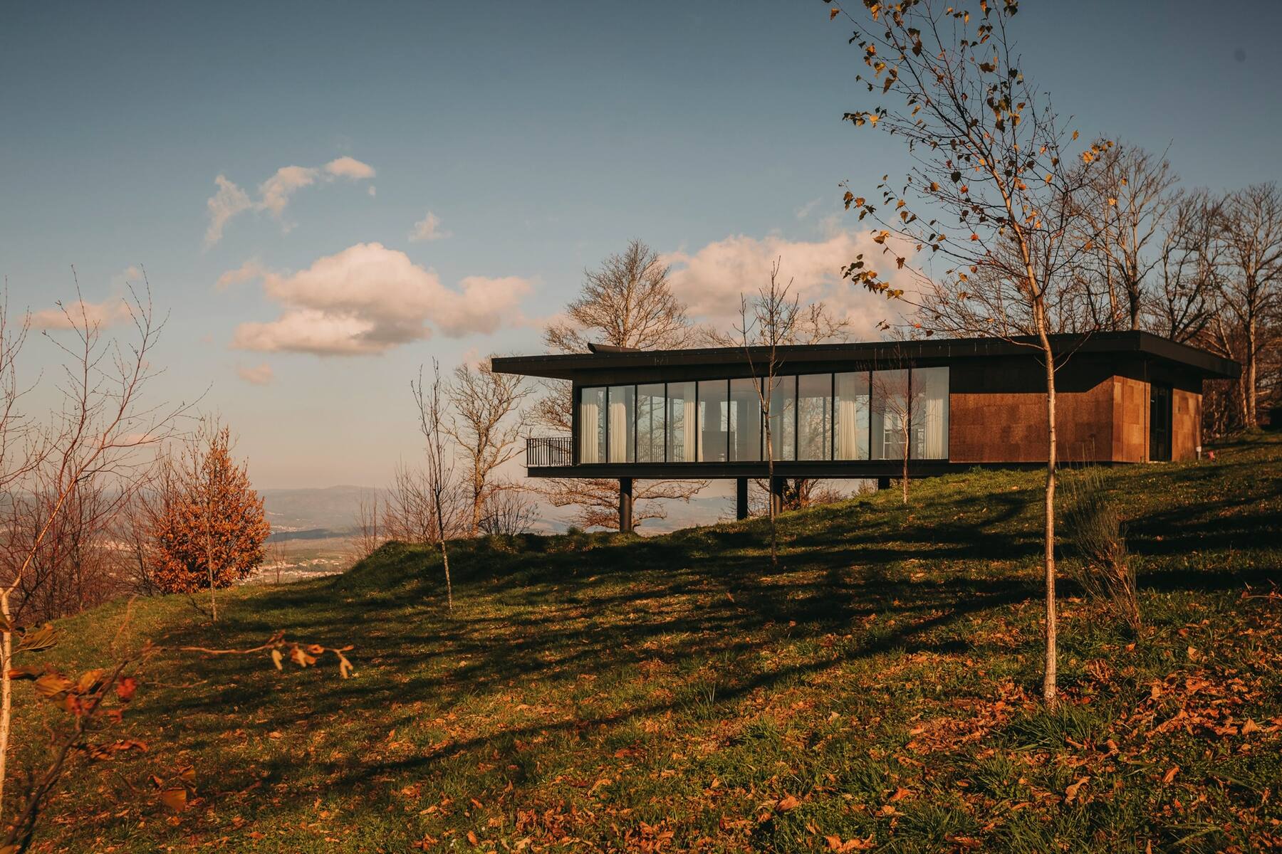 The contemplative hall — glass walls overlooking the valley